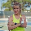 Female athlete with smartwatch and water bottle